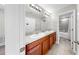 Bathroom boasts dual sinks, framed mirrors, and modern lighting fixtures for a luxurious feel at 11201 Hudson Hills Ln, Riverview, FL 33579