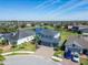 This aerial view showcases the home, its lush landscaping, and proximity to community amenities at 11305 Emerald Shore Dr, Riverview, FL 33579