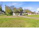 A house with a large grassy front yard and driveway in a residential neighborhood at 1155 27Th S Ave, St Petersburg, FL 33705