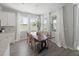 Bright dining area featuring a modern light fixture and plenty of light from the many surrounding windows at 11615 Cleyera Ct, Riverview, FL 33579