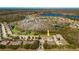 Aerial view showcasing townhomes nestled among lush greenery, with scenic lakes in the background at 11903 Castine St, New Port Richey, FL 34654