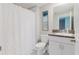Bathroom with shower and tub combo, granite counters, white cabinets and a modern design at 11903 Castine St, New Port Richey, FL 34654