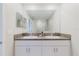 Bathroom featuring double sink vanity with granite counters and modern fixtures at 11903 Castine St, New Port Richey, FL 34654