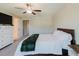 Bright bedroom featuring a ceiling fan, carpet flooring and a large dresser with TV at 11903 Castine St, New Port Richey, FL 34654