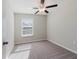 Neutral bedroom with carpet, a window with blinds and a ceiling fan with light at 11903 Castine St, New Port Richey, FL 34654