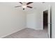 Bright bedroom featuring a closet, carpet, and a ceiling fan with light at 11903 Castine St, New Port Richey, FL 34654