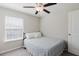 Bedroom with ceiling fan, natural light, and a patterned quilt at 11903 Castine St, New Port Richey, FL 34654