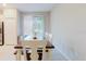 Dining area with a modern table, chairs, and natural light from the sliding glass doors at 11903 Castine St, New Port Richey, FL 34654