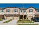 Inviting exterior view of townhomes with attached garages and manicured lawns at 11903 Castine St, New Port Richey, FL 34654