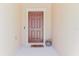 Stylish front door entrance with a welcome mat and decorative potted plant at 11903 Castine St, New Port Richey, FL 34654