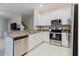 Modern kitchen features stainless steel appliances, granite countertops, and white cabinetry at 11903 Castine St, New Port Richey, FL 34654