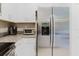 Stainless steel refrigerator and granite countertops enhance the kitchen's sleek, modern design at 11903 Castine St, New Port Richey, FL 34654