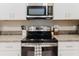 Updated kitchen with stainless steel appliances, granite countertops and stylish hardware at 11903 Castine St, New Port Richey, FL 34654