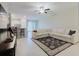 Spacious living room with a large sectional couch, ceiling fan, and neutral walls at 11903 Castine St, New Port Richey, FL 34654