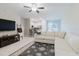 Comfortable living room with a sofa, television, and open access to the kitchen and dining area at 11903 Castine St, New Port Richey, FL 34654