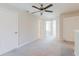 Open loft area with neutral carpet and ceiling fan at 11903 Castine St, New Port Richey, FL 34654