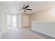Carpeted open loft space features natural light, ceiling fan and closet at 11903 Castine St, New Port Richey, FL 34654