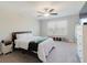 Spacious main bedroom featuring a ceiling fan, large window, and neutral carpet at 11903 Castine St, New Port Richey, FL 34654