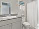 Clean bathroom with gray vanity, granite countertop, and white shower curtain at 12296 Keyridge Loop, Largo, FL 33778