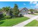 Charming home boasts a three-car garage, paver driveway, lush lawn, and mature landscaping at 12296 Keyridge Loop, Largo, FL 33778