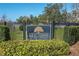 Close-up of the Keystone Ridge community sign set amongst manicured shrubs and an iron fence at 12296 Keyridge Loop, Largo, FL 33778