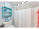 Bathroom featuring a toilet, shower with curtain, and decorative shelving at 12300 Vonn Rd # 2104, Largo, FL 33774