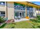 Exterior view of a condo's patio, framed by sliding glass doors and a small garden at 12300 Vonn Rd # 2104, Largo, FL 33774