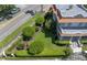 An aerial side view of the home highlighting the manicured front lawn and lush landscaping at 1311 Beach Ne Dr, St Petersburg, FL 33701