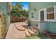 A charming backyard with a brick patio, lush greenery, and seamless outdoor to indoor access at 1311 Beach Ne Dr, St Petersburg, FL 33701