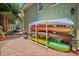 A backyard featuring a kayak storage rack and a brick paved pathway, connecting to a lounge area at 1311 Beach Ne Dr, St Petersburg, FL 33701