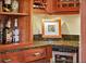 Close up of the bar showcasing granite countertops, custom lighting, and wine storage at 1311 Beach Ne Dr, St Petersburg, FL 33701