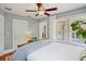 Bedroom with a large bed, ceiling fan, wood floors and large windows at 1311 Beach Ne Dr, St Petersburg, FL 33701