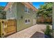 Home's exterior featuring unique textured walls, charming windows, and a brick paved driveway and walkway at 1311 Beach Ne Dr, St Petersburg, FL 33701