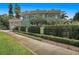 A lush green lawn and manicured hedges frame the charming home, creating an inviting outdoor space at 1311 Beach Ne Dr, St Petersburg, FL 33701