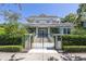 Stunning two-story home featuring a gated entrance, lush landscaping, and a unique architectural style at 1311 Beach Ne Dr, St Petersburg, FL 33701