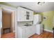 This quaint kitchen features a stacked washer and dryer and stainless steel sink at 1311 Beach Ne Dr, St Petersburg, FL 33701
