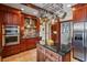 A well-equipped kitchen featuring wooden cabinetry, stainless steel appliances, and granite countertops at 1311 Beach Ne Dr, St Petersburg, FL 33701