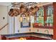 Charming kitchen with a hanging pot rack, granite countertops, and lush greenery outside the window at 1311 Beach Ne Dr, St Petersburg, FL 33701