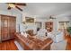 Spacious living room featuring a white brick fireplace, hardwood floors, and lots of natural light at 1311 Beach Ne Dr, St Petersburg, FL 33701