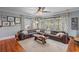 Bright living room featuring a leather sectional, neutral rug, and many windows for natural light at 1311 Beach Ne Dr, St Petersburg, FL 33701