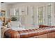 Cozy living room with a mix of textures, plantation shutters, and access to the outdoors at 1311 Beach Ne Dr, St Petersburg, FL 33701