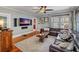 Cozy living room with hardwood floors, a plush sectional sofa, and a ceiling fan at 1311 Beach Ne Dr, St Petersburg, FL 33701
