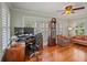 Office space showcasing hardwood floors, large windows with shutters, and dark wood desk at 1311 Beach Ne Dr, St Petersburg, FL 33701