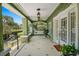Charming porch with white tile flooring, ceiling fans, and cozy swing for relaxing at 1311 Beach Ne Dr, St Petersburg, FL 33701