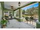 Spacious covered porch with outdoor seating, tiled floors, and views of the front yard at 1311 Beach Ne Dr, St Petersburg, FL 33701