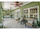 Inviting porch with comfortable seating, ceiling fans, and views of the well-maintained landscaping at 1311 Beach Ne Dr, St Petersburg, FL 33701