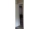 View into bedroom with wood floors and dark gray curtains at 1554 Tilley Ave, Clearwater, FL 33756