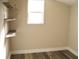 Bedroom with wood-look flooring, closet, and a bright window at 1554 Tilley Ave, Clearwater, FL 33756