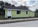 Exterior view of a charming single-story home with green siding at 1554 Tilley Ave, Clearwater, FL 33756