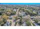An aerial view showcases two homes surrounded by mature trees in a tranquil residential setting at 1800 27Th N Ave, St Petersburg, FL 33713